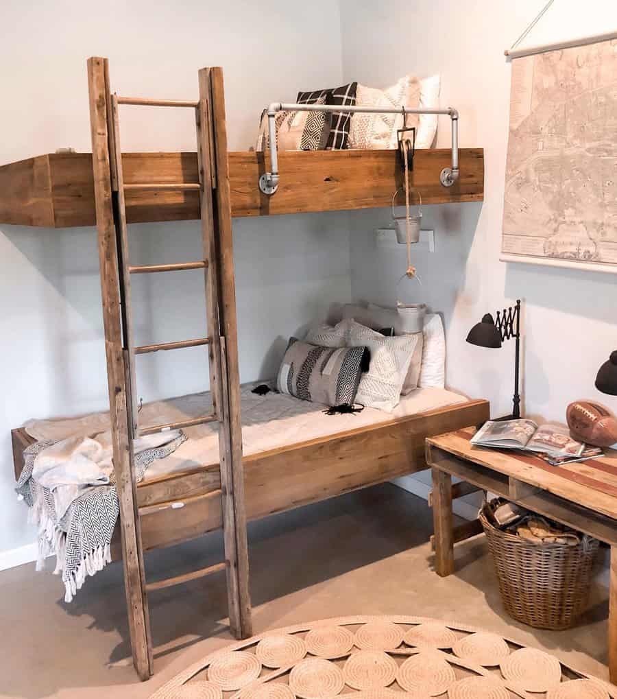 Cozy bedroom with wooden bunk beds, a ladder, and a bedside table with books and a football in neutral tones and textured blankets