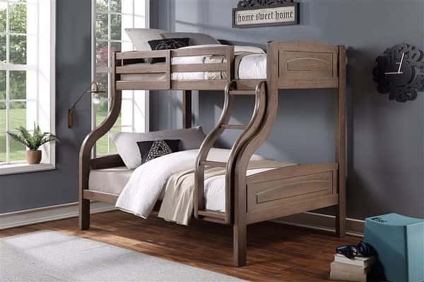 Wooden bunk bed with a curved design in a room with grey walls, a window, and a "home sweet home" sign