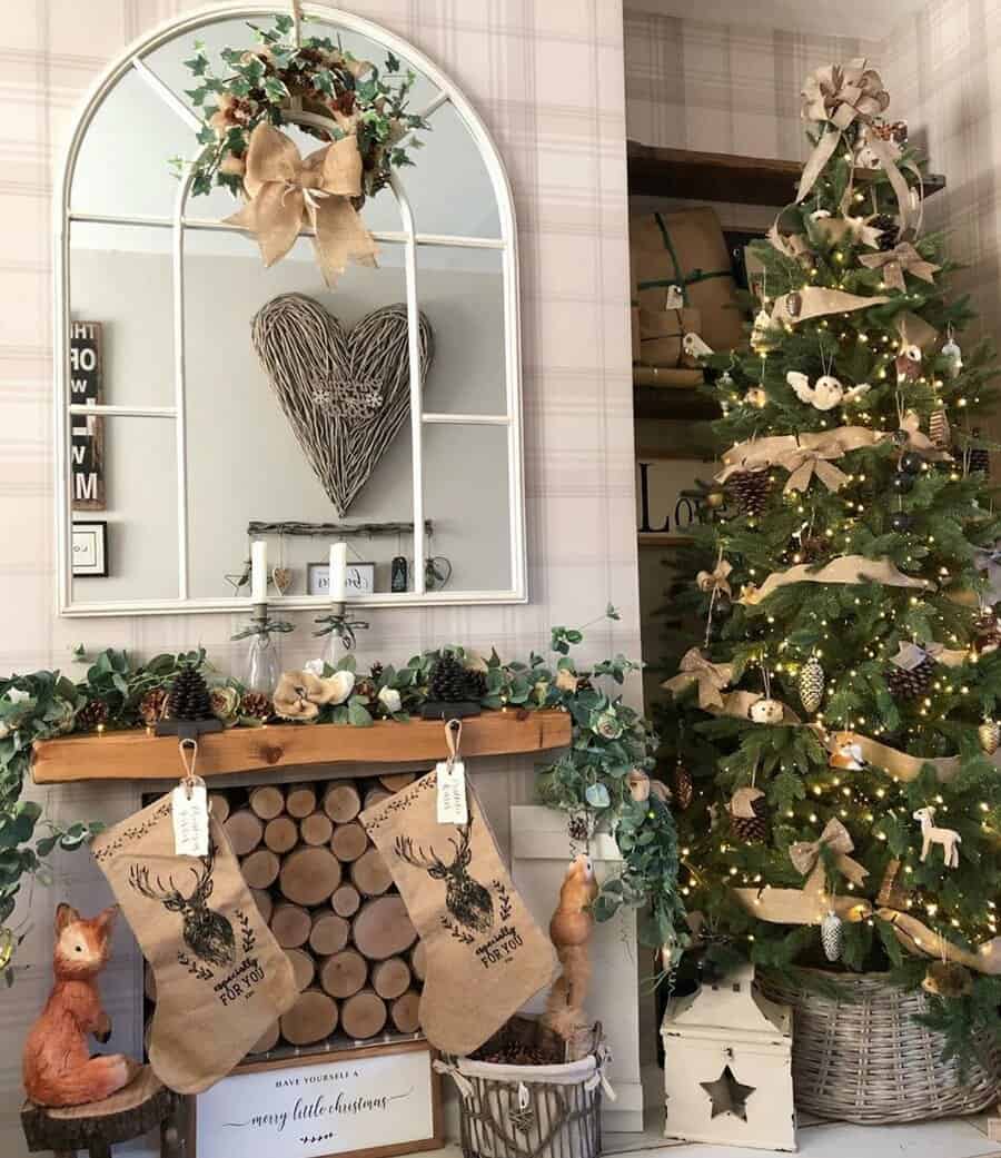 Cozy Christmas decor with stockings, tree, mirror, and knit heart on the wall