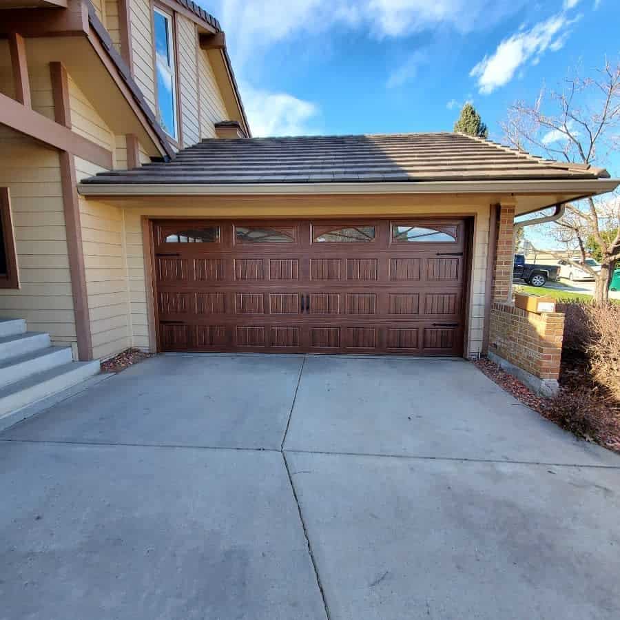 Beige house with a wooden patterned garage door