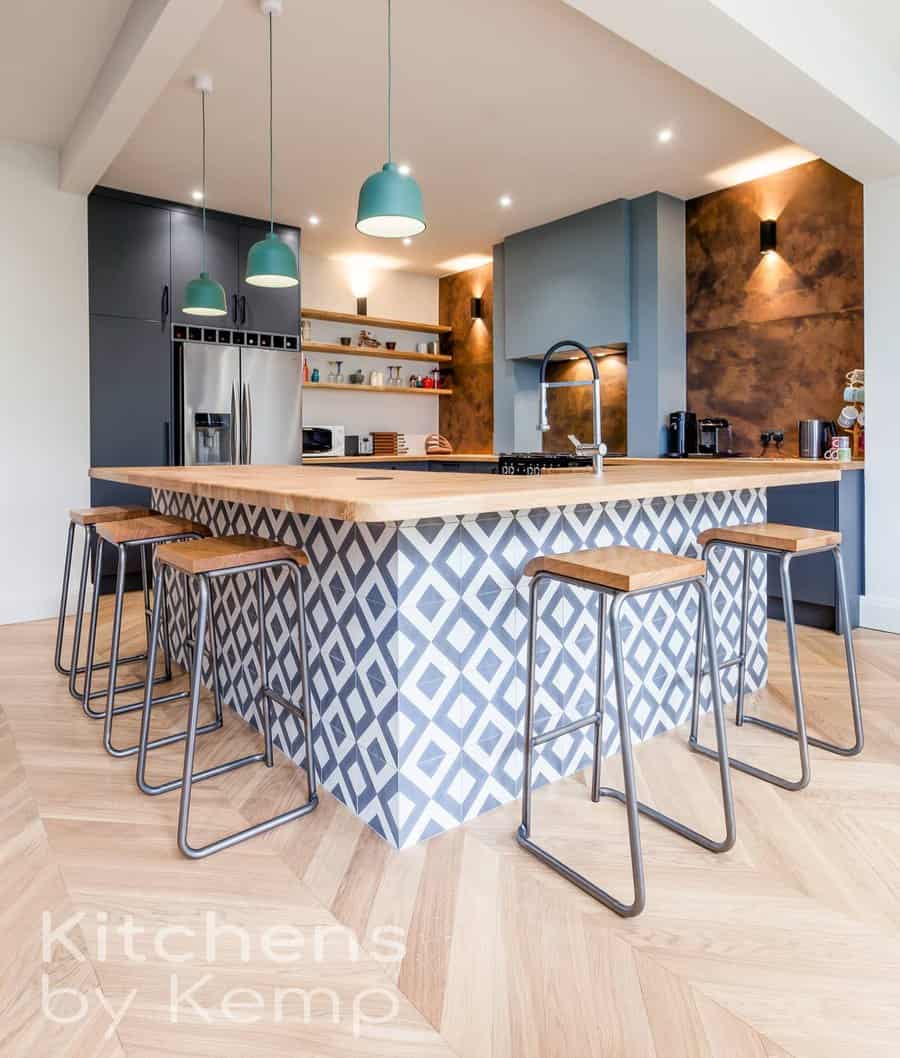 Stylish kitchen with patterned island and teal lights