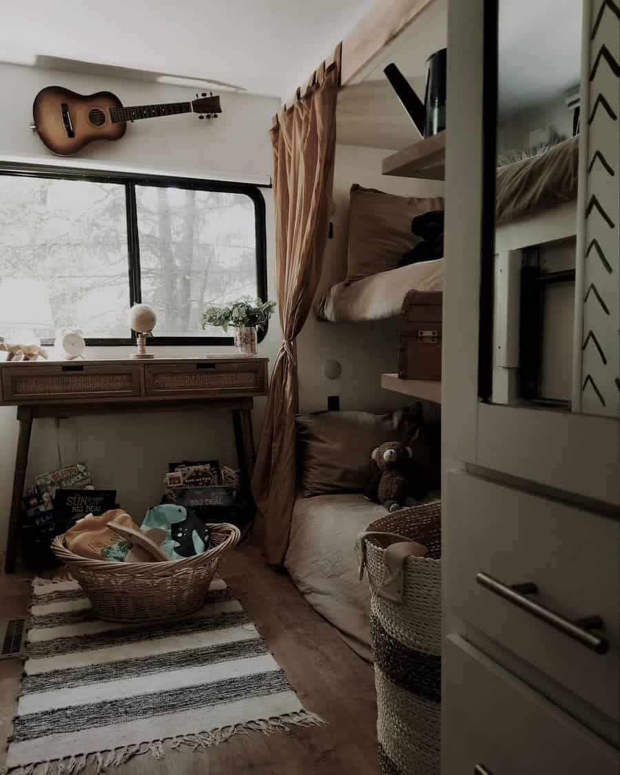 Rustic RV interior with guitar and cozy textiles