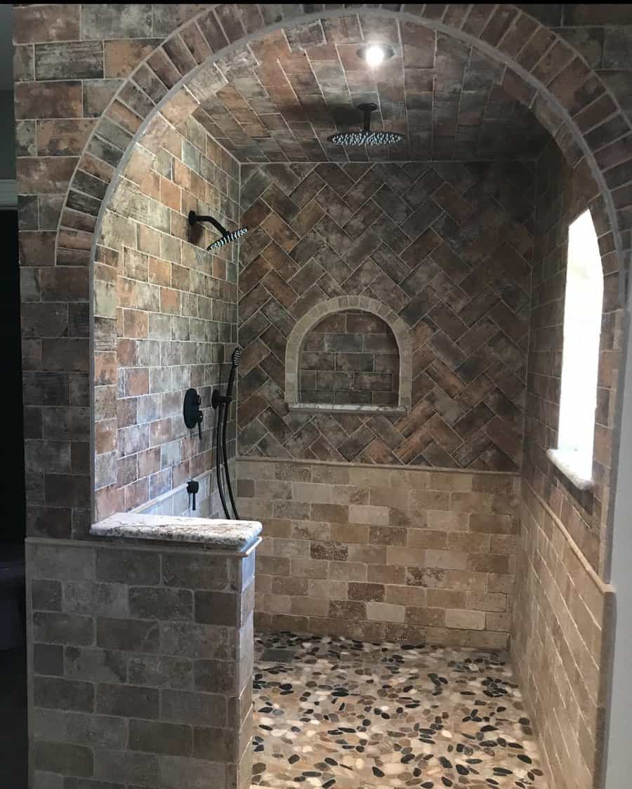 rustic walk-in shower with stamped stone tiles