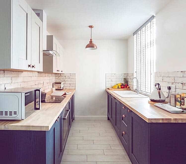 small galley kitchen with wooden countertop