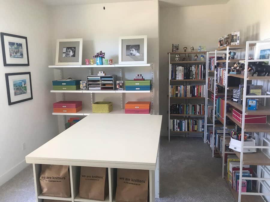 Bright craft room with shelving units and large table