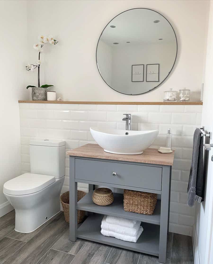 Modern bathroom with grey vanity and round mirror