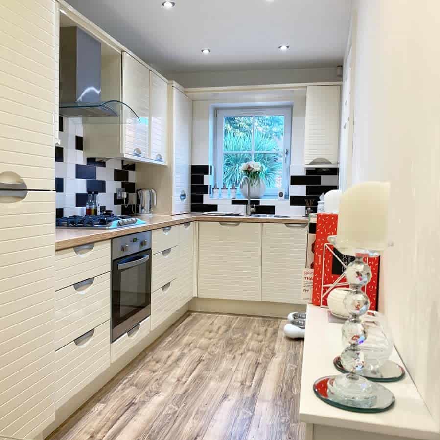 small galley kitchen with beveled tiles