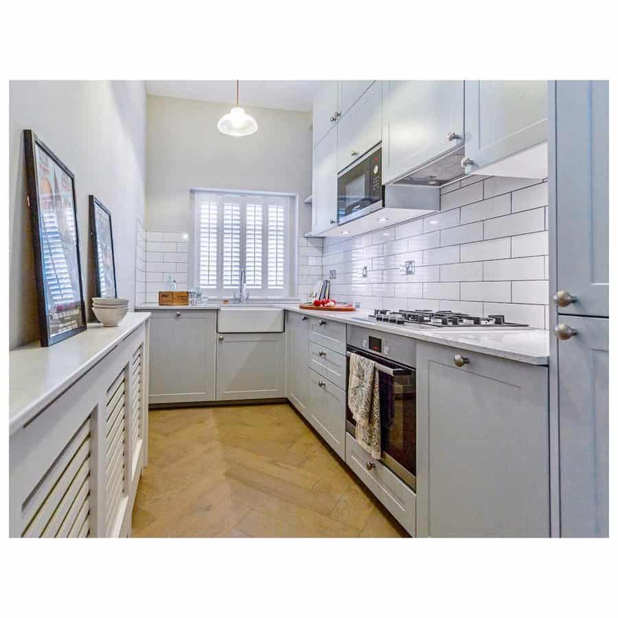 small galley kitchen with beveled tiles