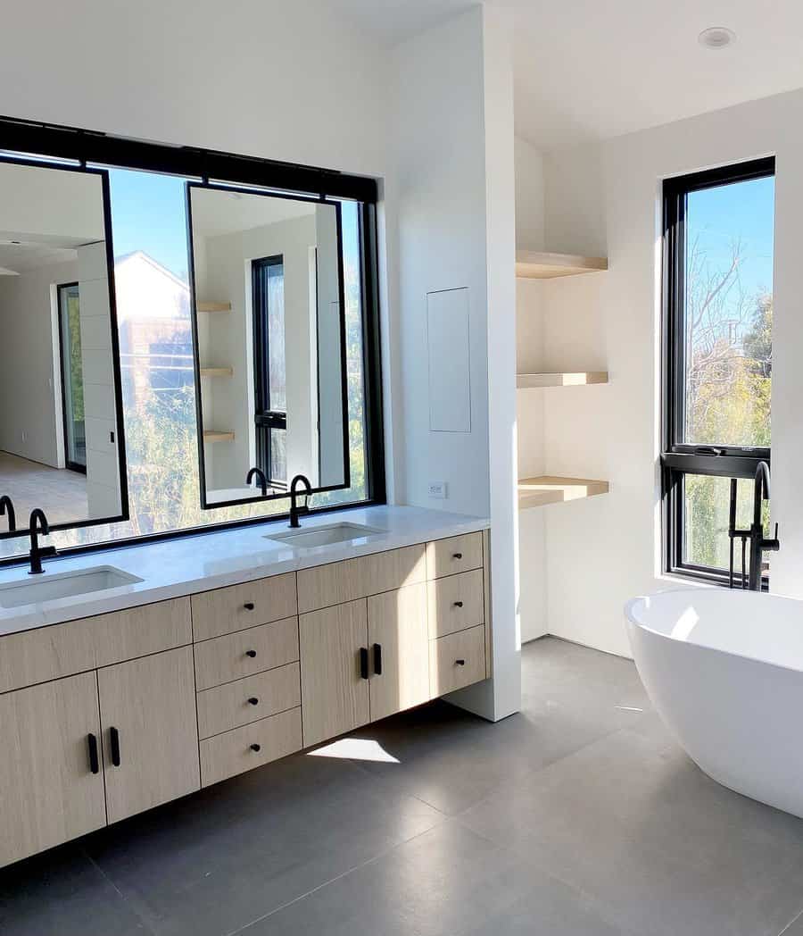 Bright bathroom with double vanity and freestanding tub