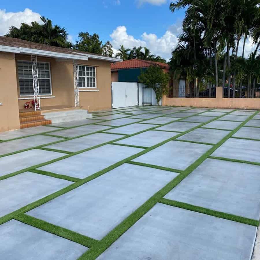 Concrete slab patio with grass joints and house exterior