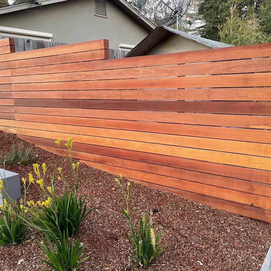 Vibrant flora enhances a wooden fence