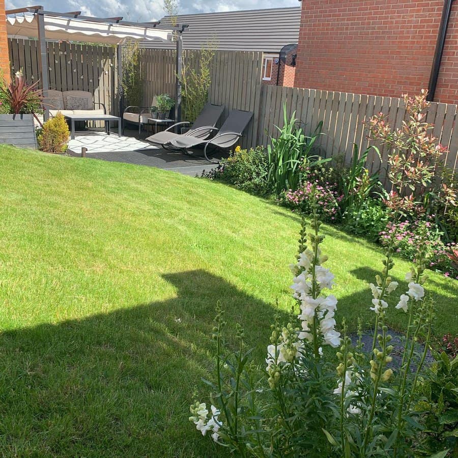 Sunny garden with loungers and patio