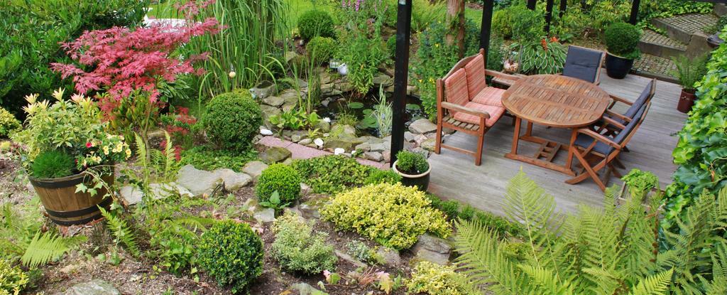 Lush garden terrace with seating and diverse plants