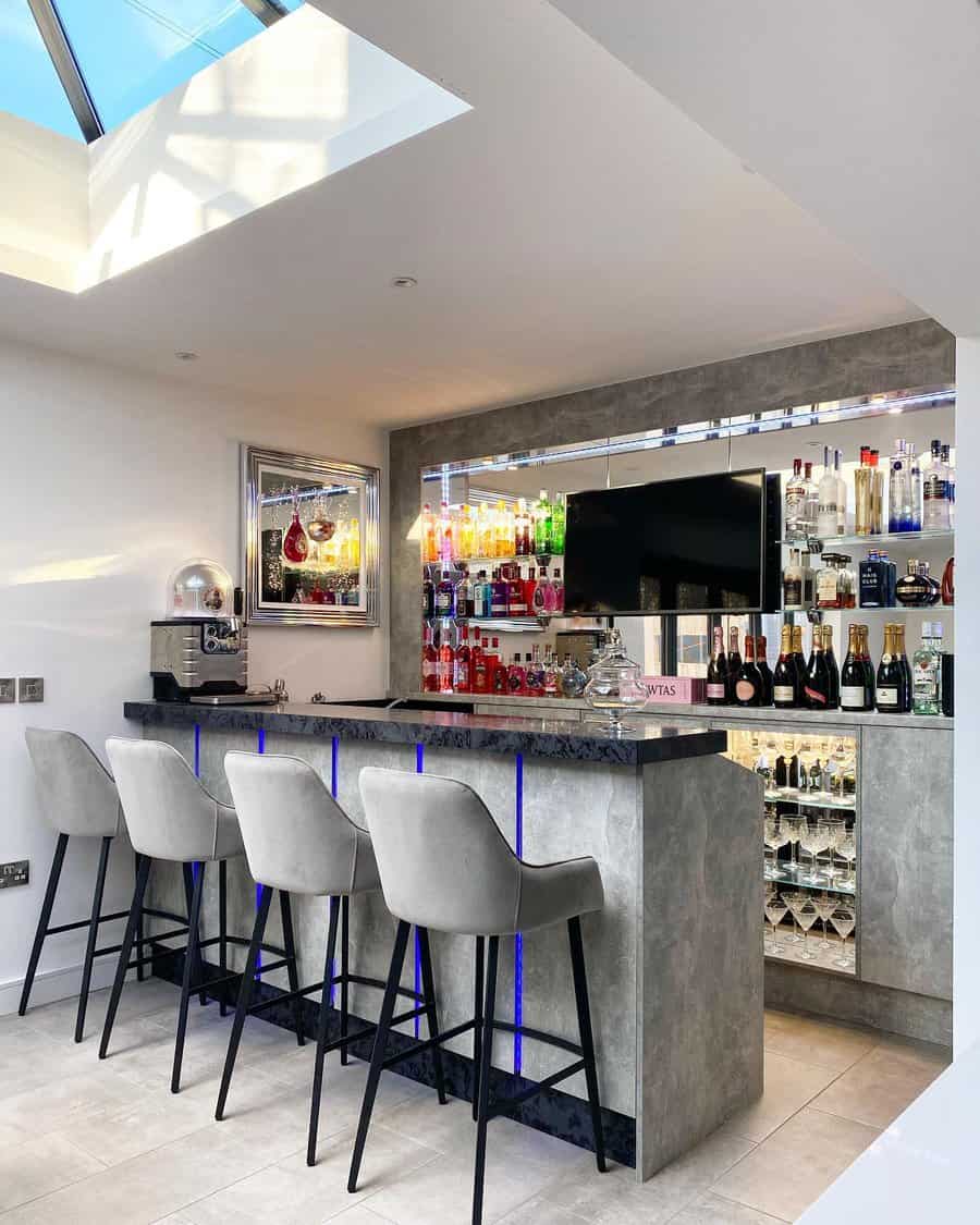 A chic bar with natural light and colorful backlighting