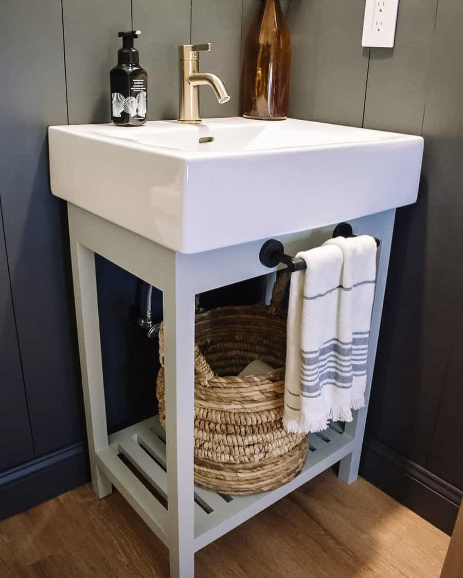 Compact vanity with white basin and storage baskets