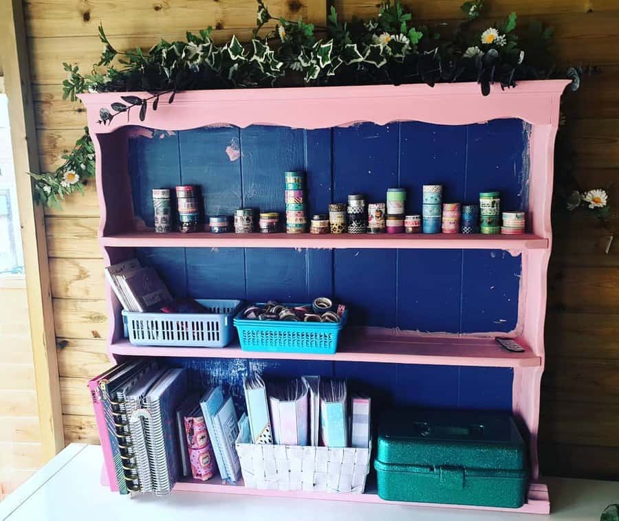 Pink and navy bookshelf with craft supplies