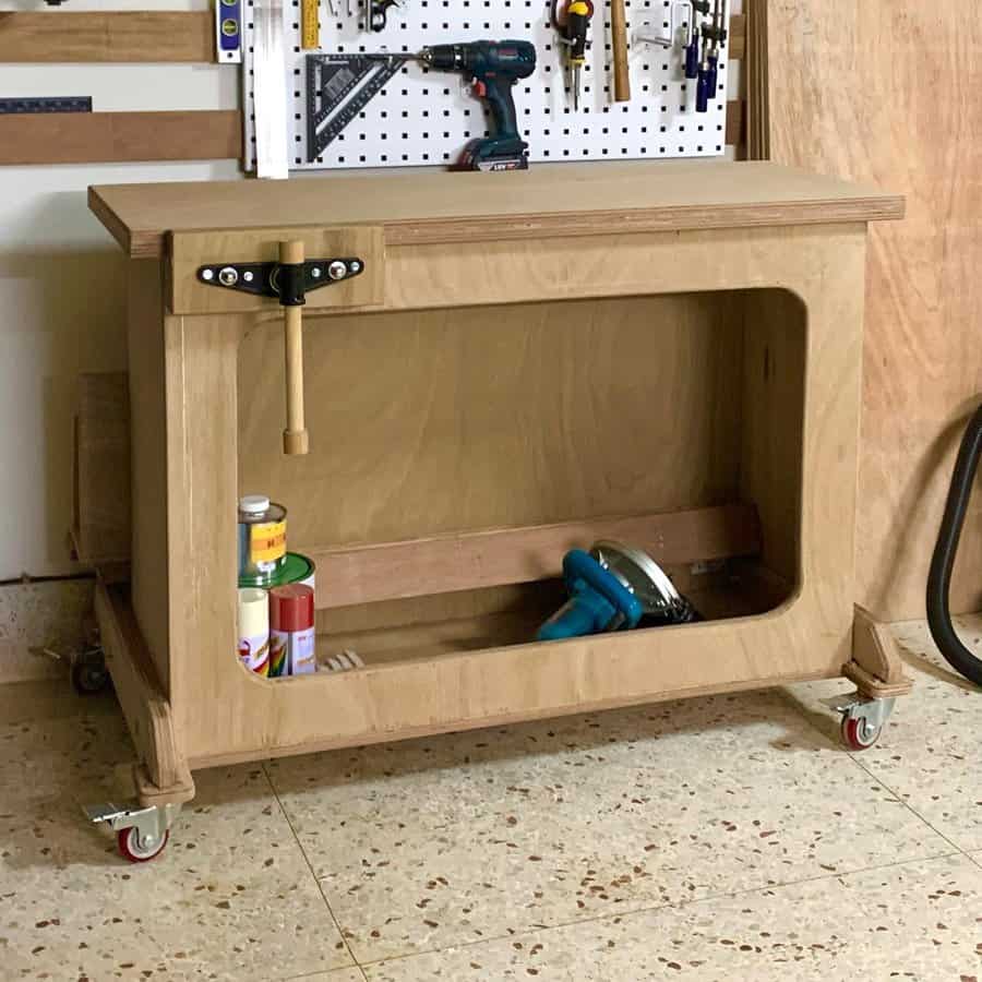 Compact wooden workbench with vise and lower shelf