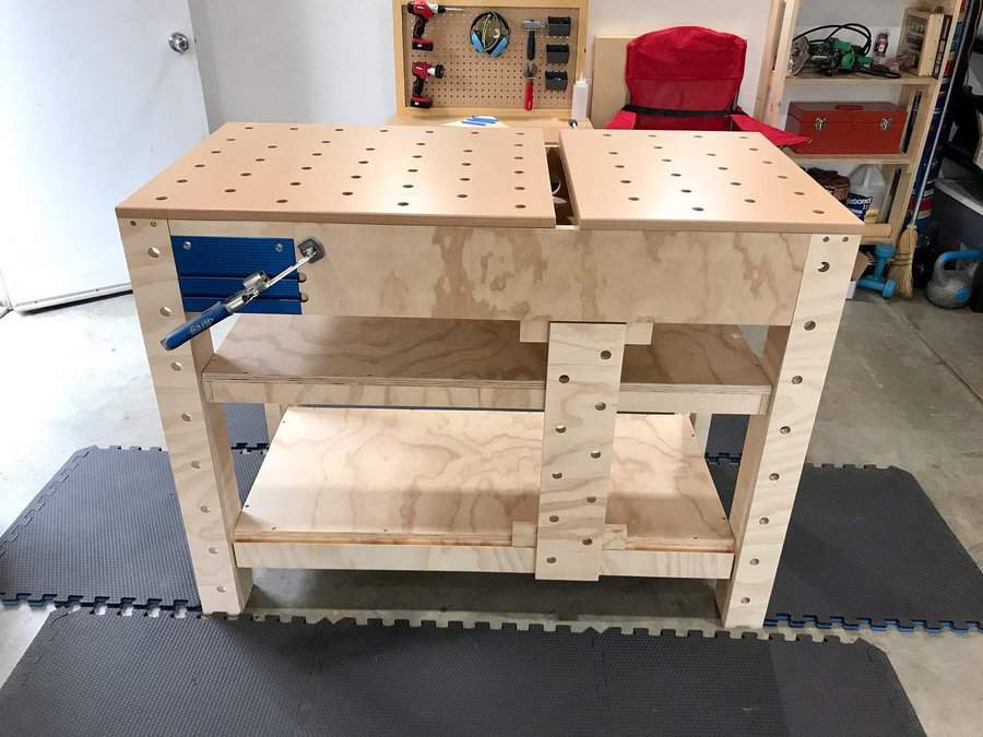 Small plywood workbench with clamps and storage shelf