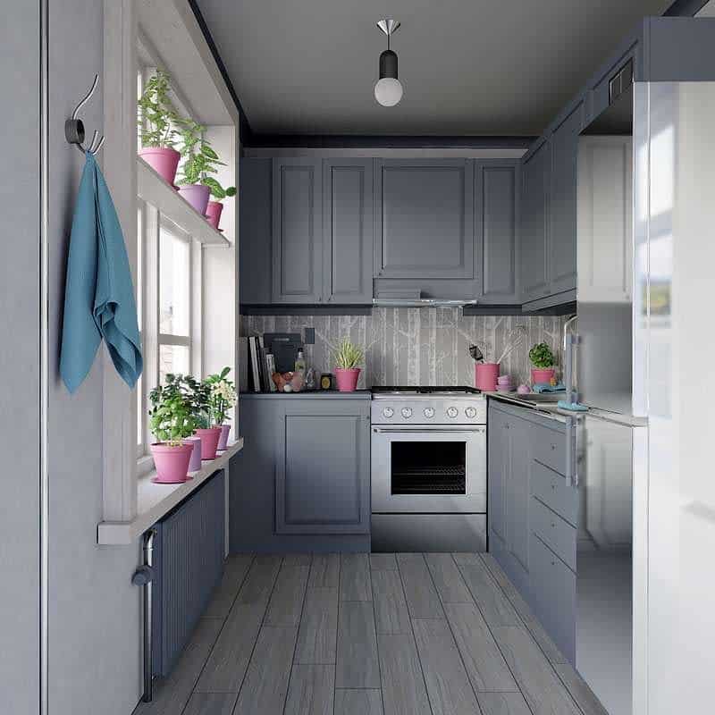 Organized kitchen with potted plants and gray cabinets