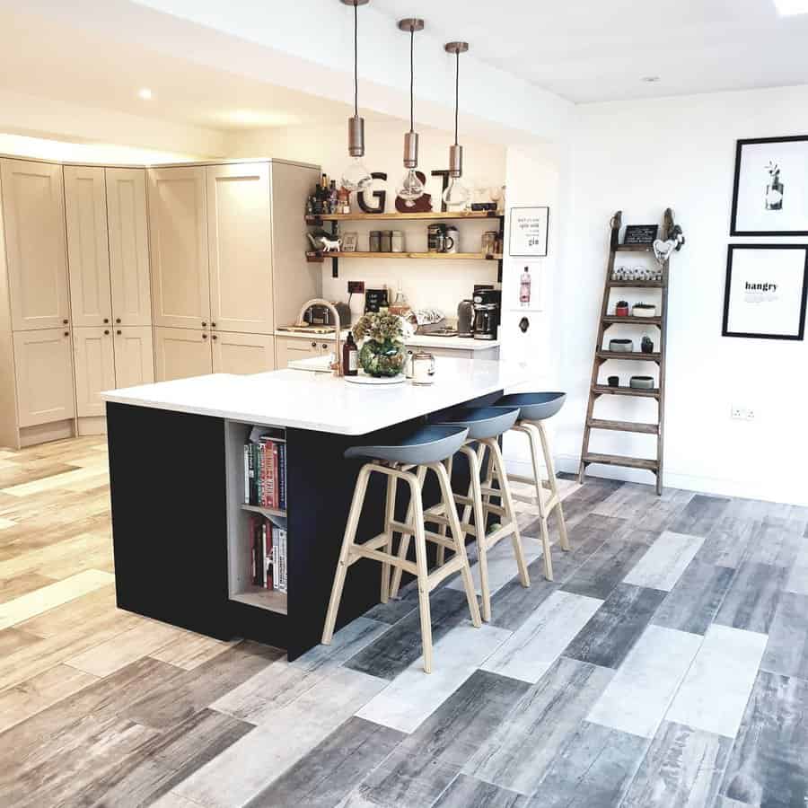 Chic kitchen with black island and wood stools