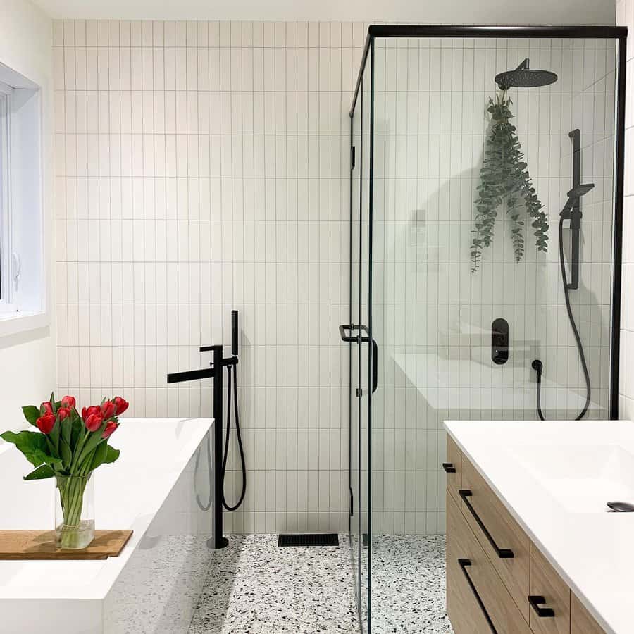 Minimalist bathroom with black fixtures and terrazzo floor