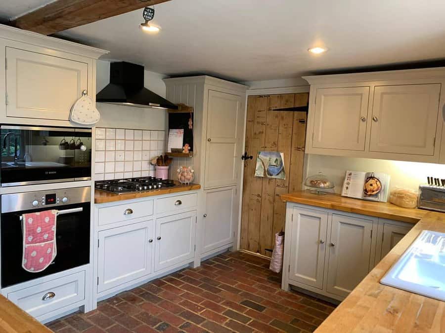 farmhouse kitchen with red brick flooring