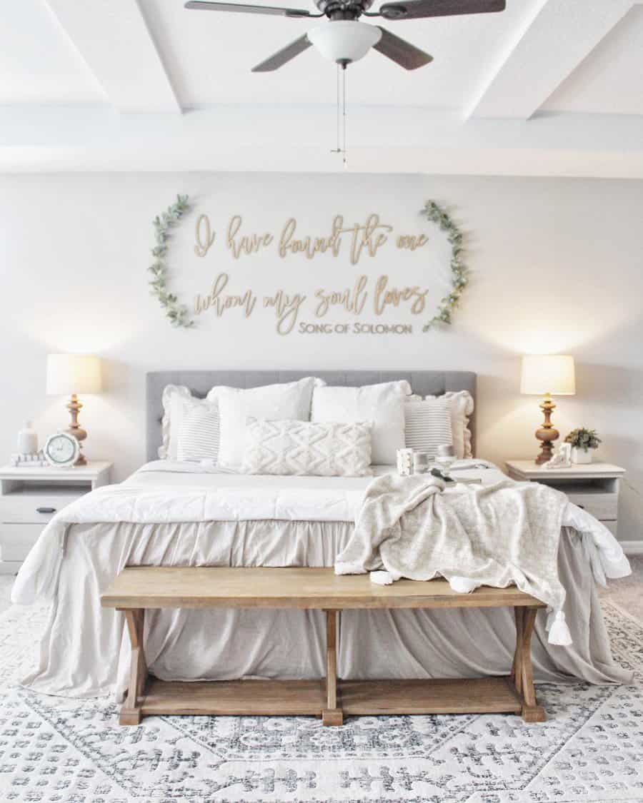 Soft Zen bedroom with neutral tones, plush bedding, a rustic wooden bench, and calming decor for a peaceful and elegant retreat