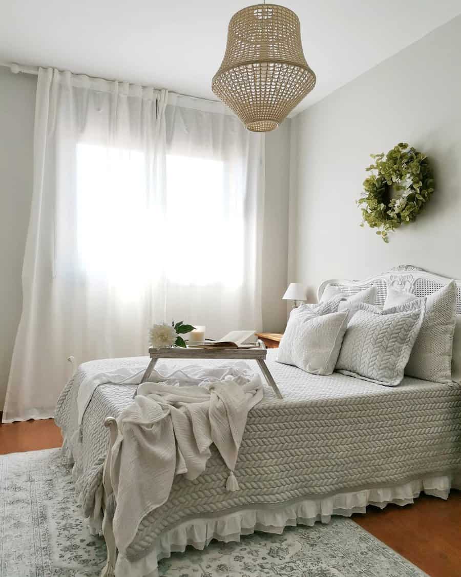 Tranquil Zen bedroom with soft neutral tones, textured bedding, sheer curtains, and natural accents for a cozy and calming retreat