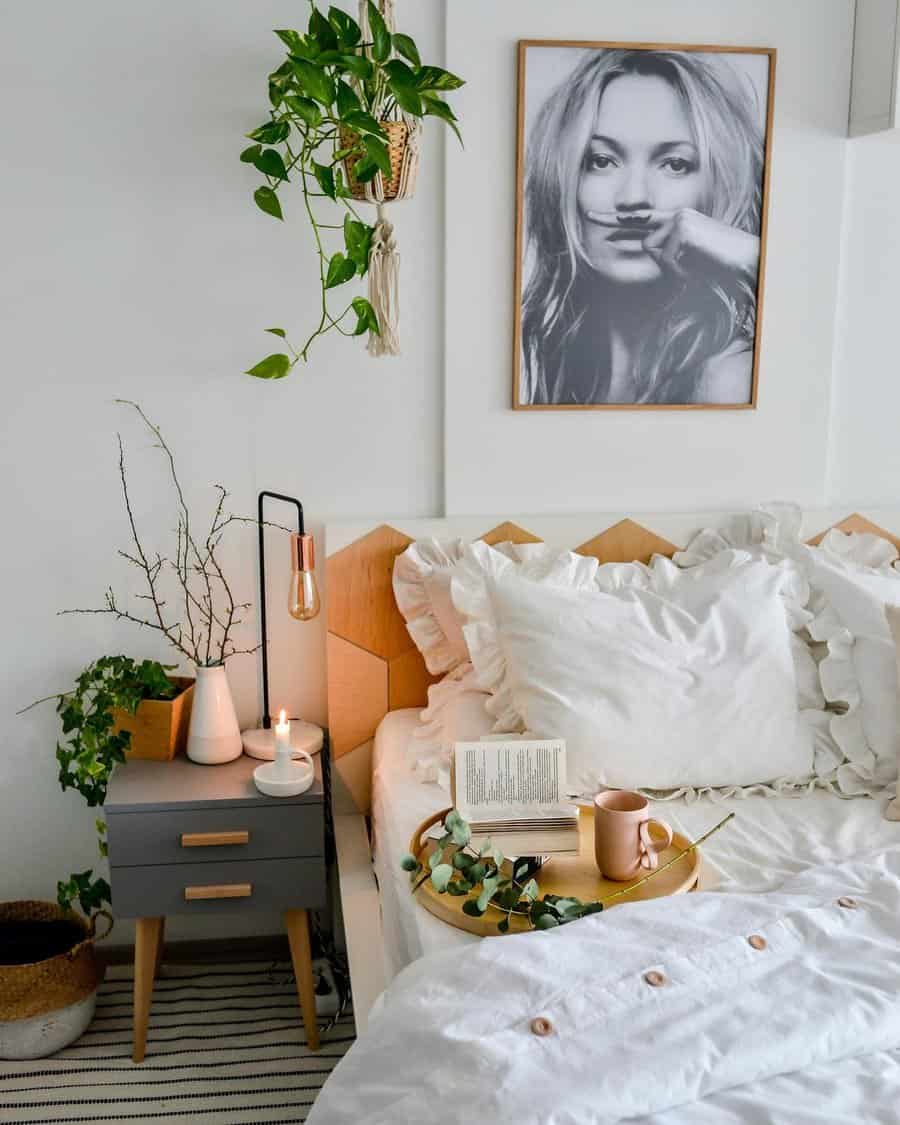 White bedroom with candle and hanging plants