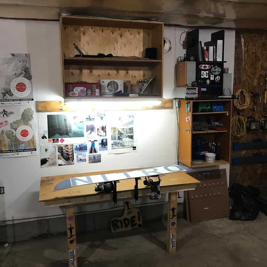 Garage workbench with lighting, storage, and wall decor