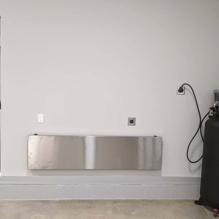 Minimalist garage with wall mounted shelf and air compressor