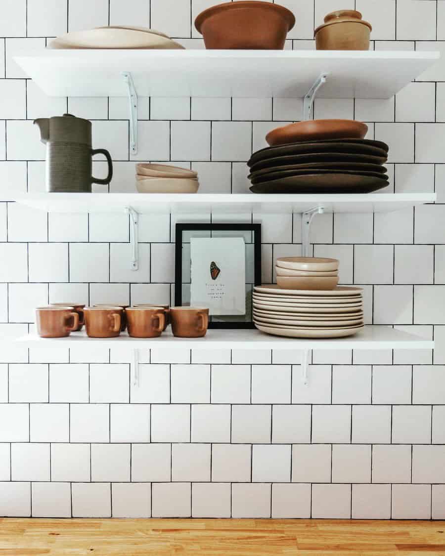 white tiles with black grout kitchen backsplash