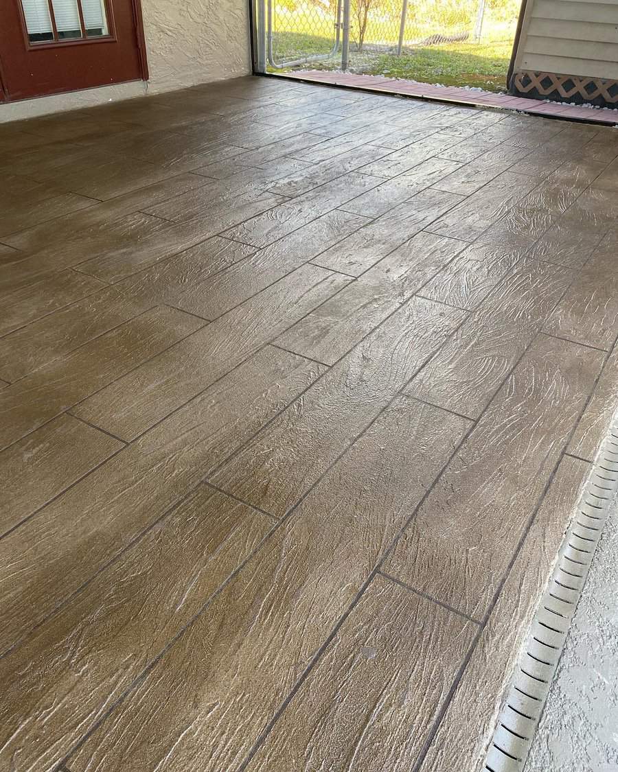 Stained concrete patio with wood plank pattern and screened porch