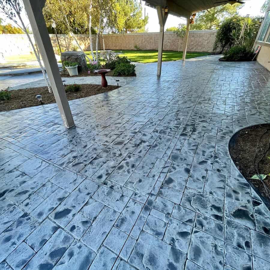 Stamped and stained concrete patio with garden and pergola