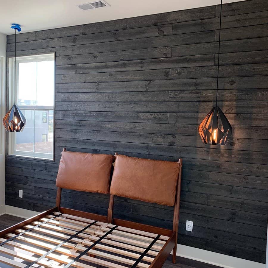 Modern bedroom with black shiplap wall and geometric pendant lights