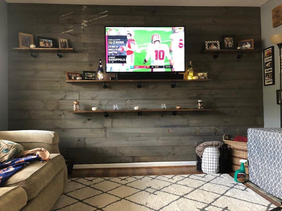 Living room with dark shiplap accent wall and mounted TV