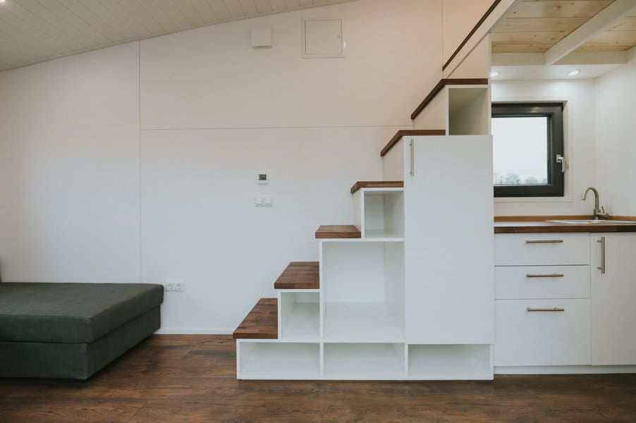 Small kitchen with seating area and staircase