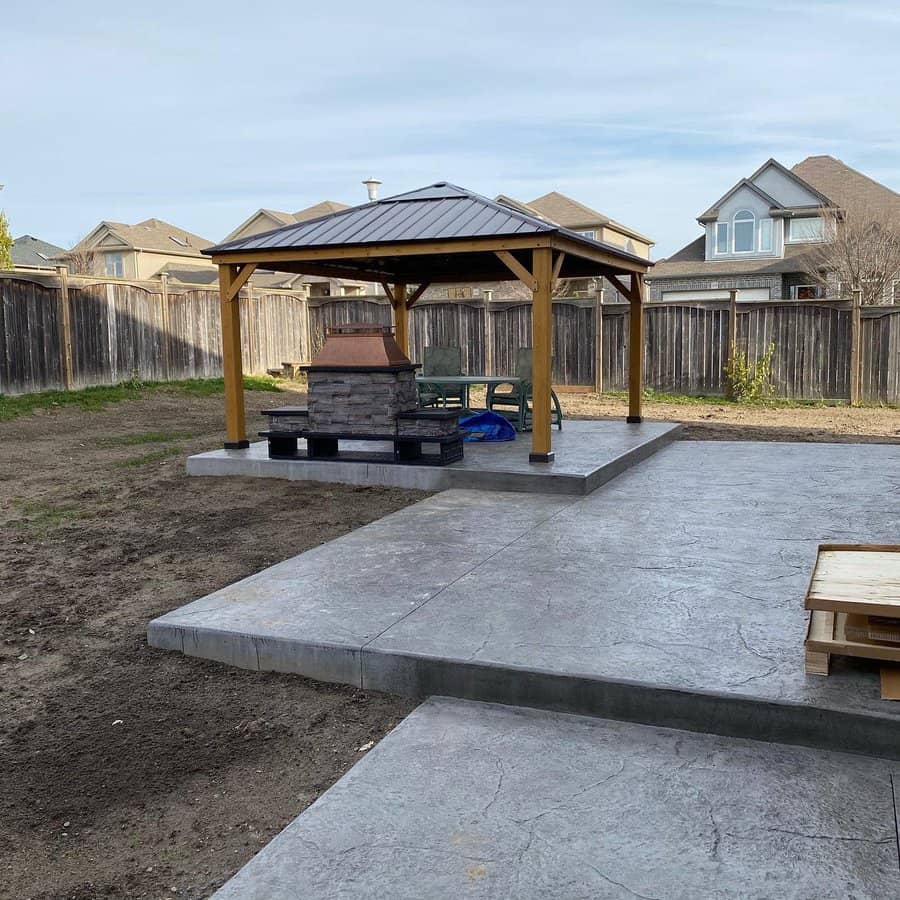 Stamped concrete patio with gazebo and outdoor fireplace