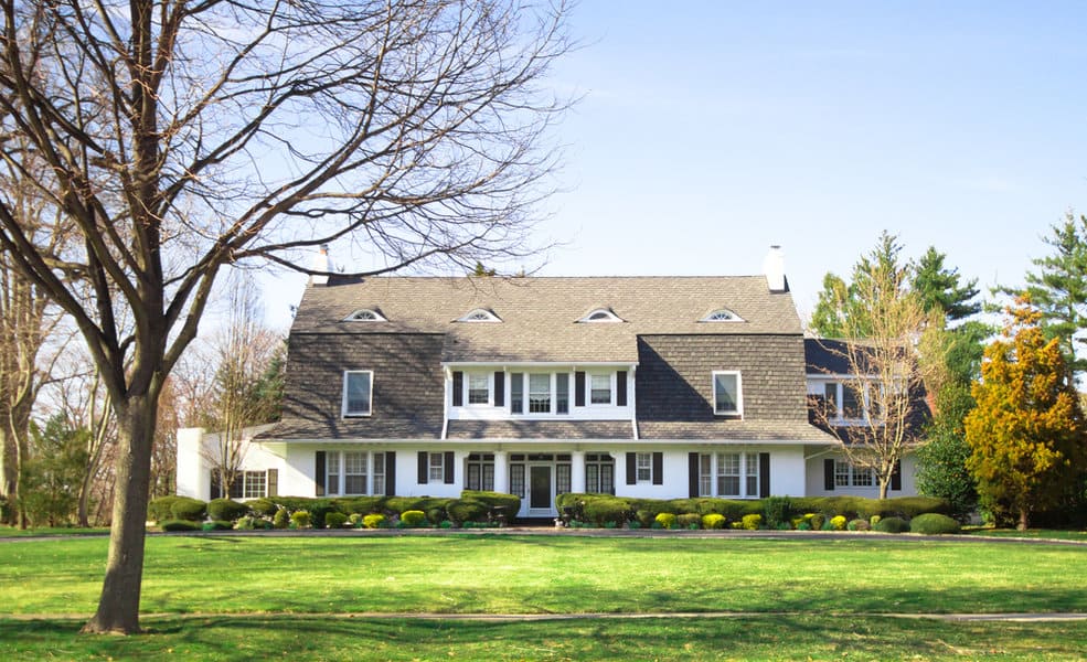 Colonial house with grass lawn