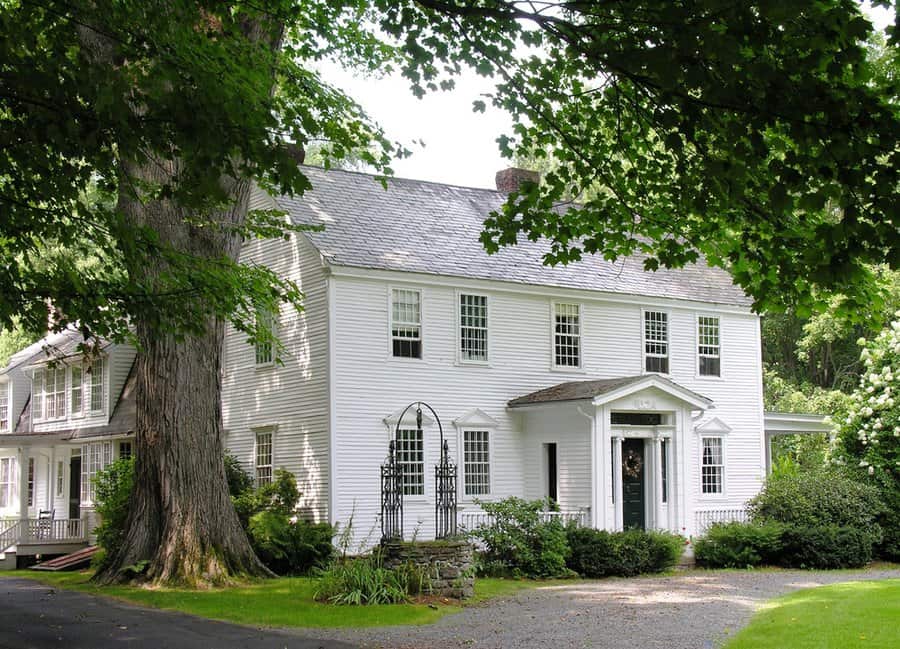 Colonial house with grass lawn