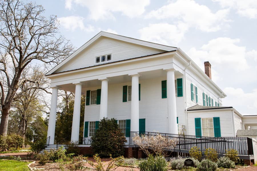 White colonial house with shiplap walls