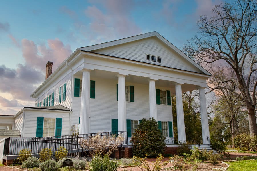 White colonial house with shiplap walls