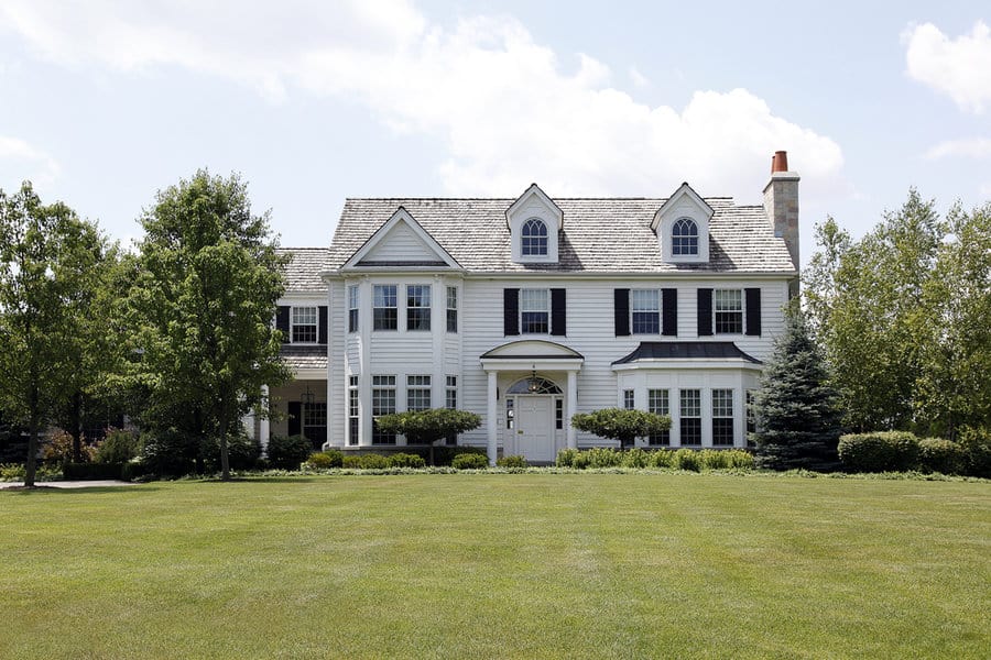 White colonial house with shiplap walls