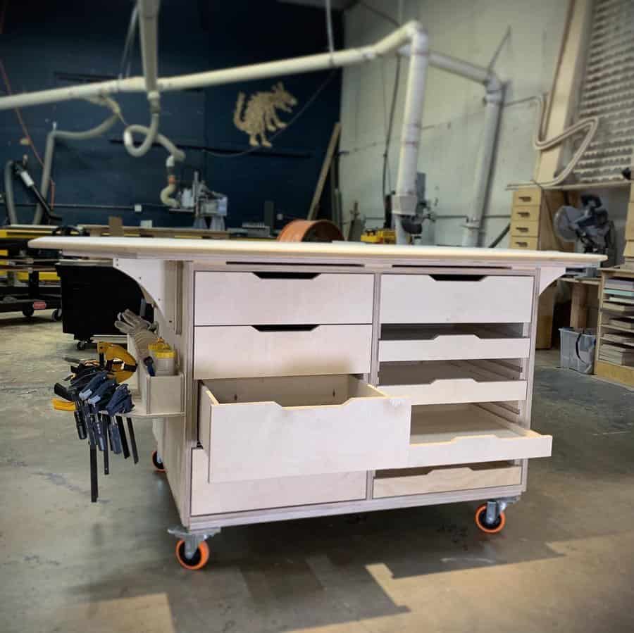 Mobile workbench with open drawers and clamp storage