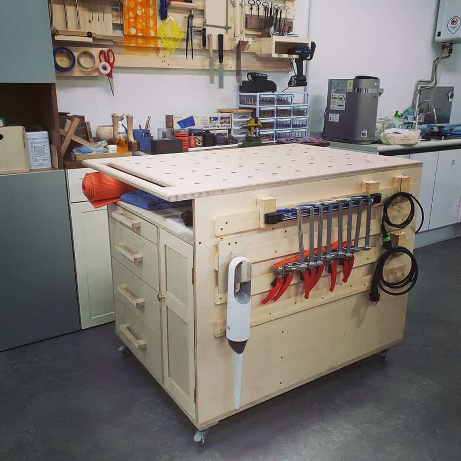 Wooden mobile workbench with pegboard top and tool holders