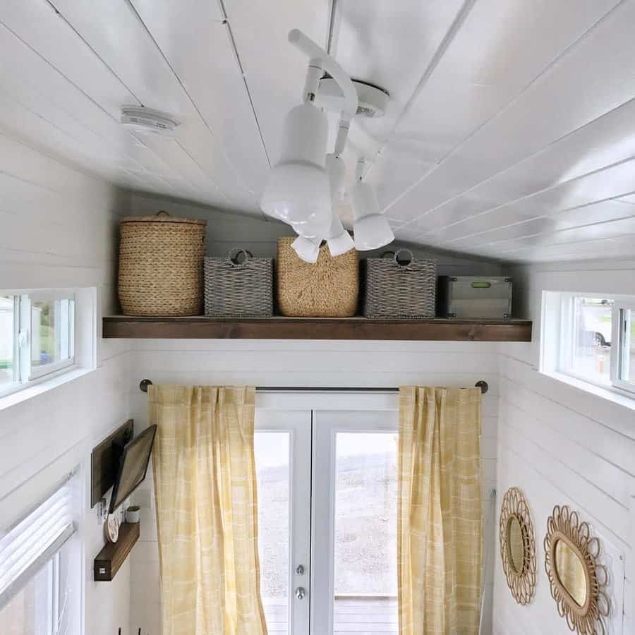 Small room with overhead shelves and wicker storage 
