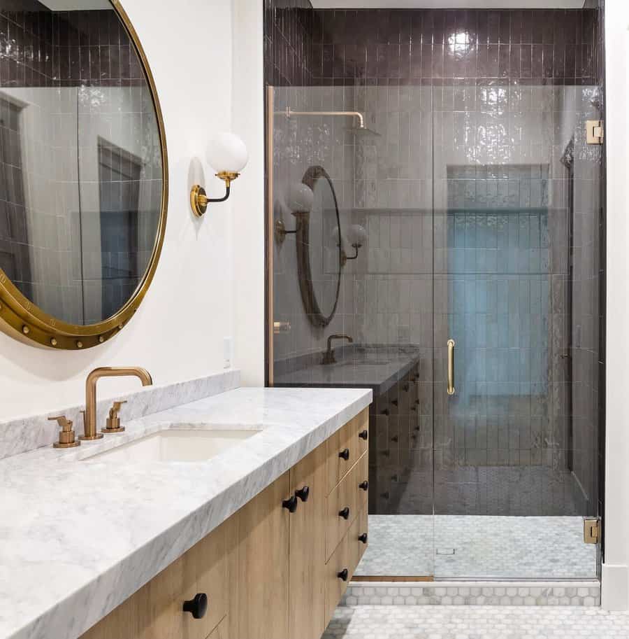 Chic bathroom with gold mirror and glass shower