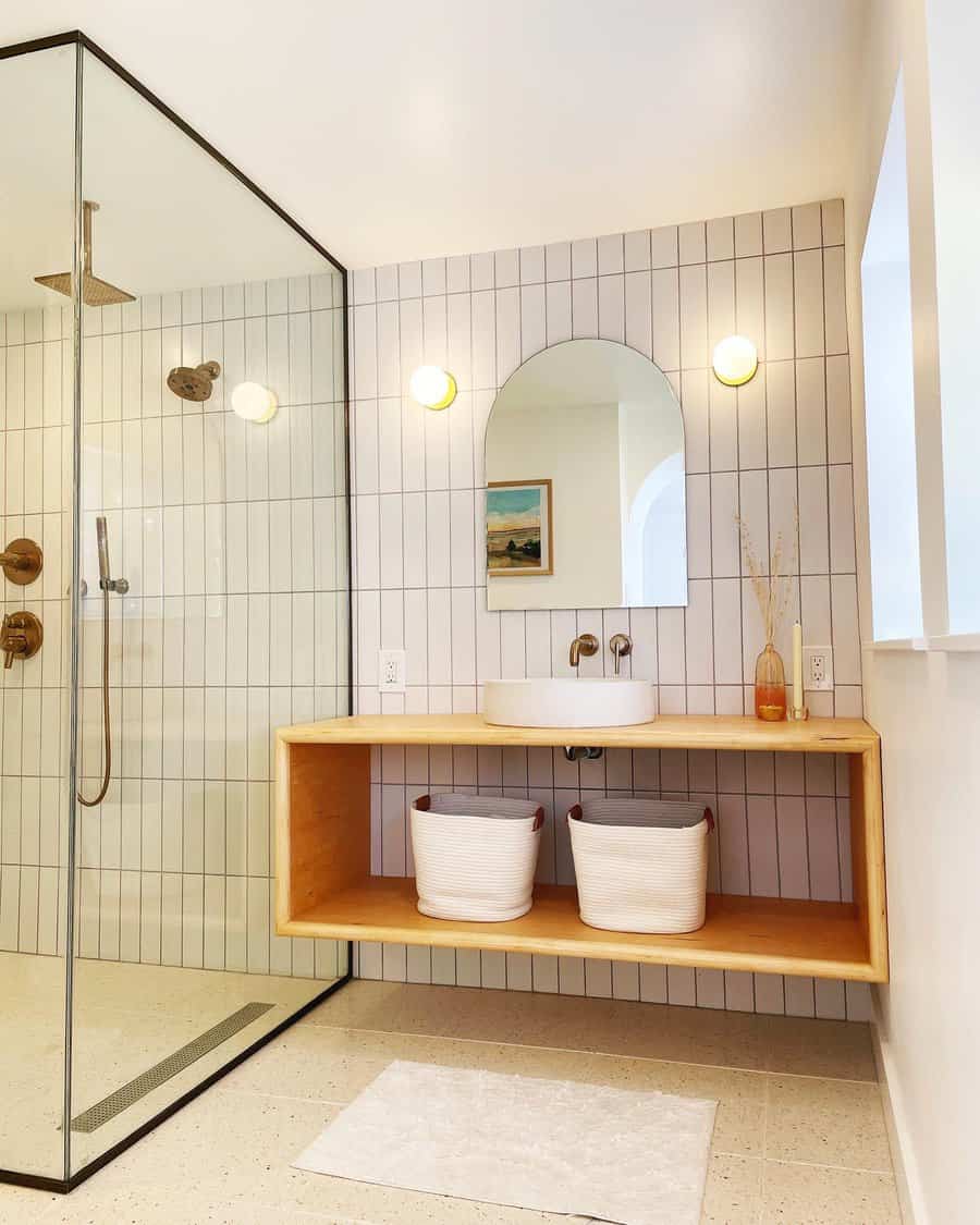 Bright bathroom with wooden vanity and tiled shower