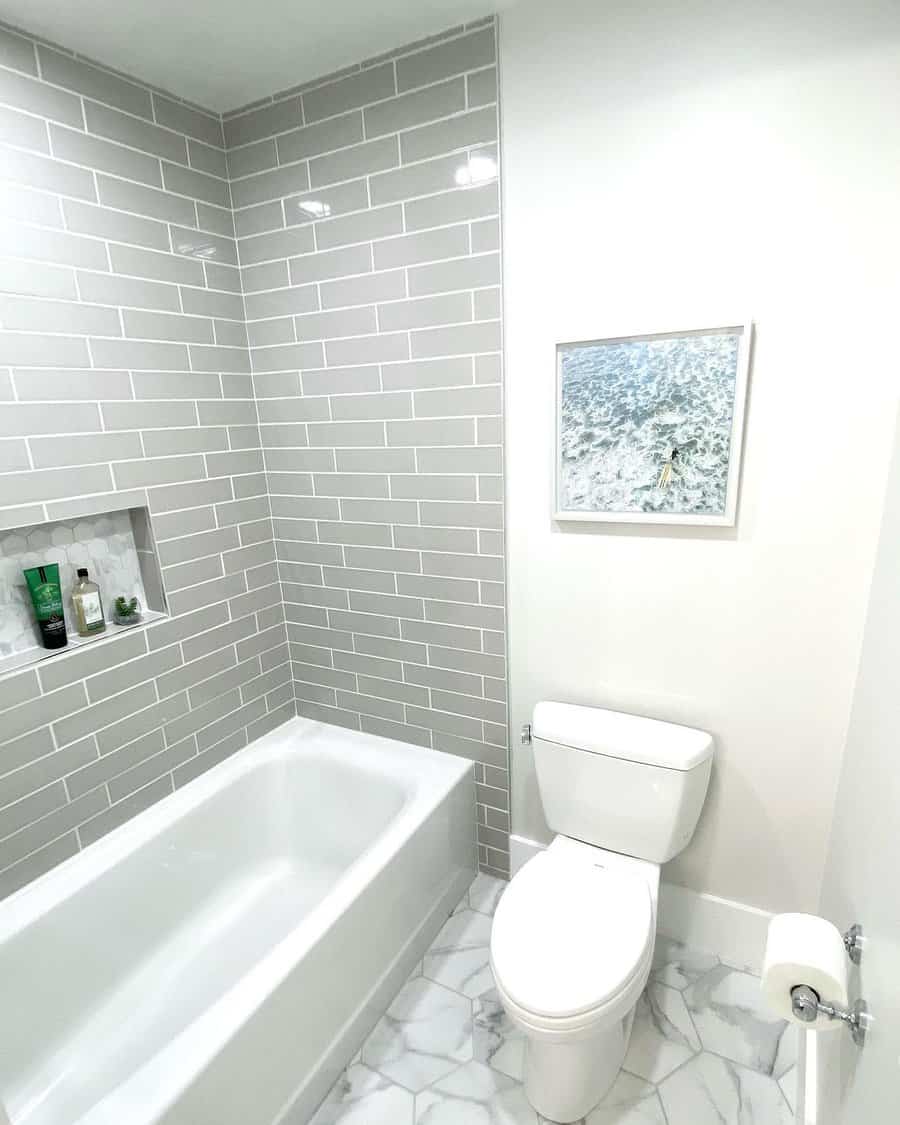 Minimalist bathroom with subway tiles and artwork