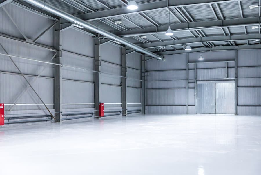 Large empty industrial garage with bright overhead lighting